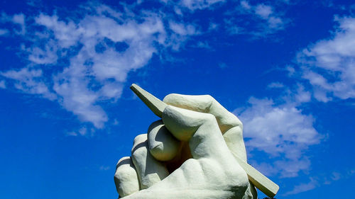 Low angle view of statue against blue sky