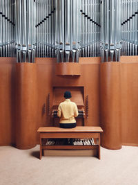 Rear view of man sitting on chair