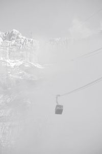 Overhead cable car against sky during winter