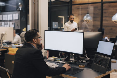 Manager using computer while working at desk in office