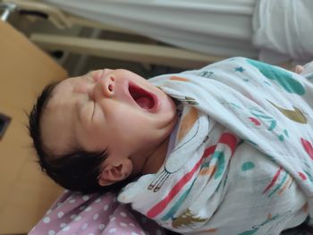 Cute baby girl sleeping on bed at home