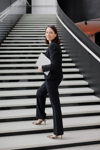 Full length of woman walking on staircase