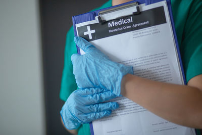 Close-up of hand holding paper