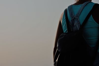 Rear view of woman standing against white background