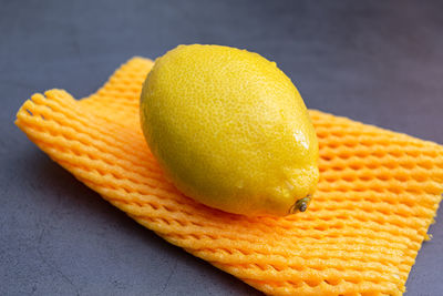 Ripe and juicy lemon lies on the package close-up