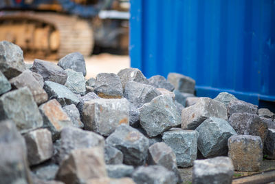 Stack of rocks against blue wall