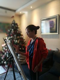 Girl painting on easel at home