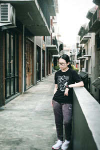 Portrait of young woman standing in city