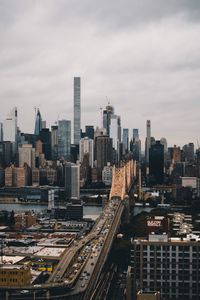 Aerial view of buildings in city against sky