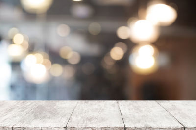 Defocused image of illuminated lights on table