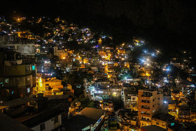 High angle view of city lit up at night