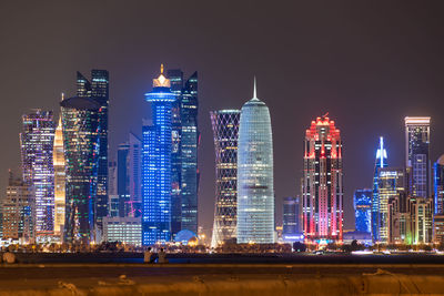 Illuminated buildings in city at night