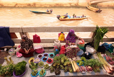 High angle view of women selling food on bridge over river