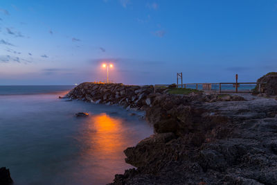 Scenic view of sea against clear sky at sunset