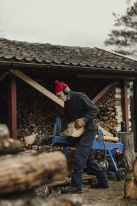 Senior man sawing wood