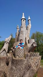 Low angle view of built structure against clear blue sky