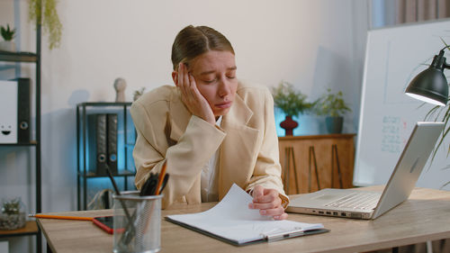 Young woman using laptop at home