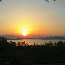 Scenic view of lake at sunset