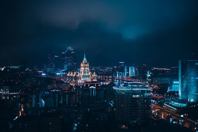 High angle view of city lit up at night