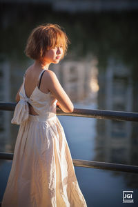 Woman looking away while standing outdoors