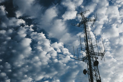 Low angle view of communications tower against sky