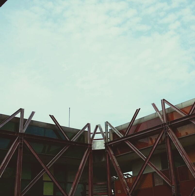 low angle view, sky, built structure, architecture, cloud - sky, building exterior, cloud, construction site, metal, cloudy, day, railing, outdoors, industry, no people, metallic, development, construction, roof, blue