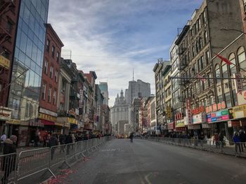 Street amidst buildings in city against sky