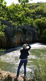 Rear view of woman standing in water