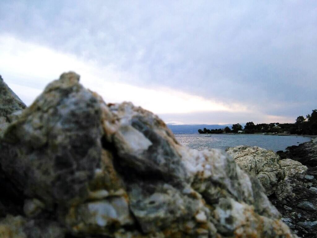 ROCKS ON SEA AGAINST SKY