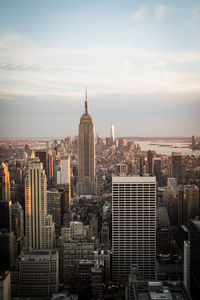 View of cityscape against cloudy sky