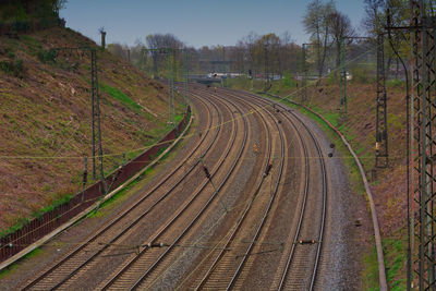 High angle view of railroad tracks on field against sky