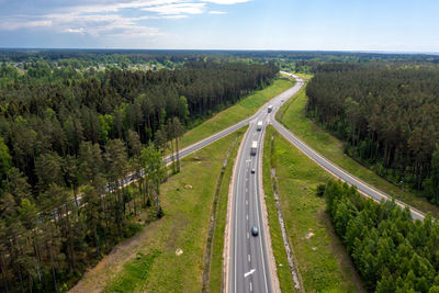 High angle view of highway amidst trees against sky