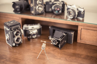 High angle view of miniature and old vintage cameras on table