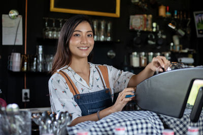 Young woman standing at cafe