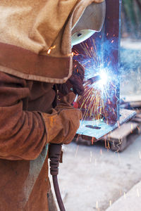 Low angle view of person working on metal