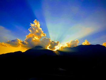 Scenic view of silhouette mountain against sky at sunset