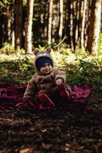 Portrait of woman standing in forest