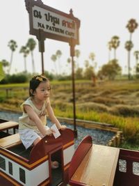 Portrait of young woman sitting on chair