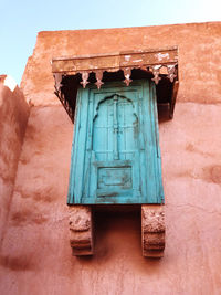 Low angle view of window on old building