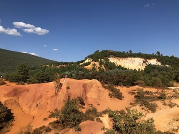 Scenic view of mountains against blue sky