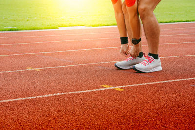 Low section of person running on road