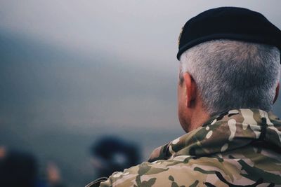 Rear view of army soldier against sky