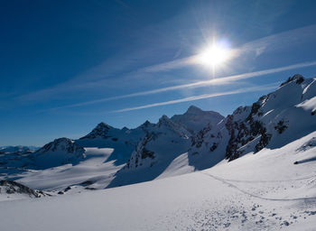 Scenic view of snow covered mountains against sky