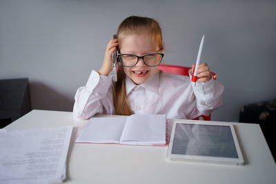 A little girl, a business lady, works at home remotely, in quarantine, teaches, training.