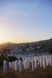 Panoramic view of cemetery against sky during sunset