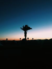 Silhouette person on landscape against clear sky during sunset