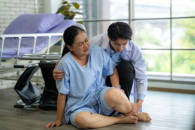 Portrait of siblings sitting on floor