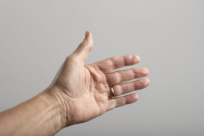 Cropped hand gesturing against white background