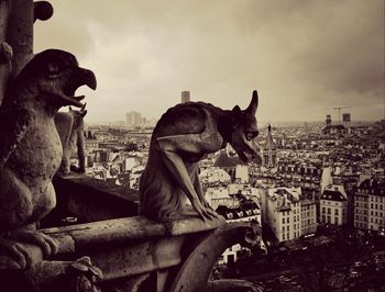 View of cityscape against cloudy sky