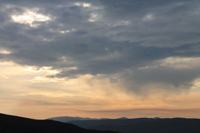 Scenic view of silhouette mountains against sky during sunset